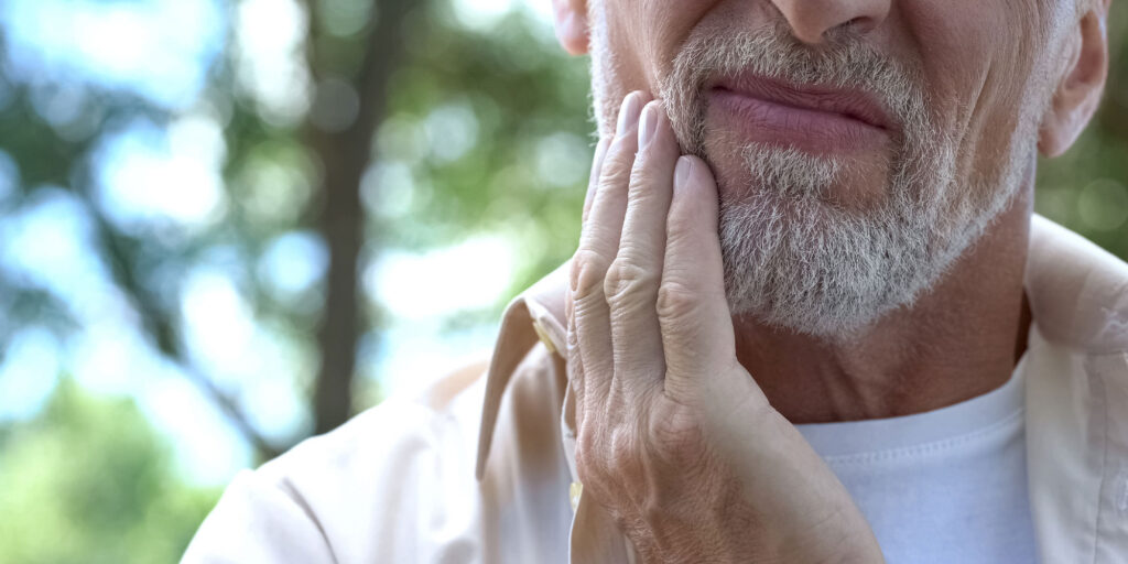 person in pain from gum disease