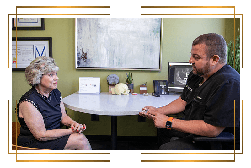 Dr. Haskell talking to patient about dental implants