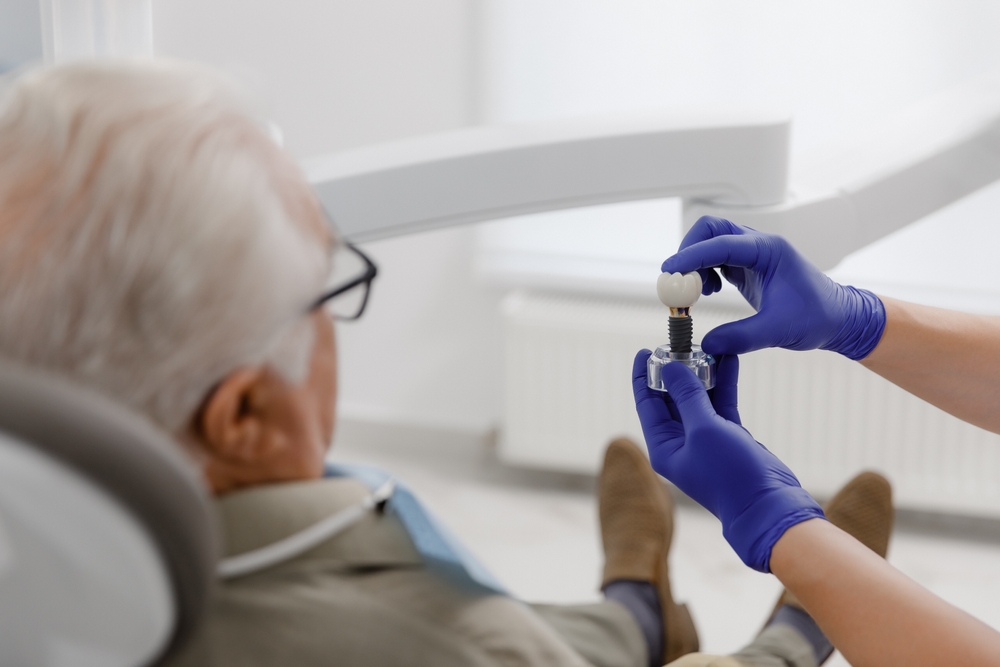 Patient consulting with Chandler implant dentist in a modern dental setting